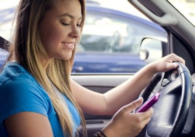 Teen girl texting while driving