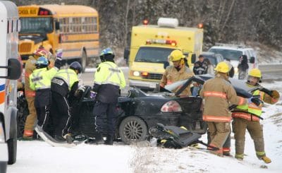Emergency response workers helping car accident victims