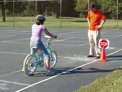 Child learning safety rules of biking