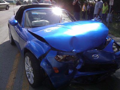 blue sedan with major accident damage 