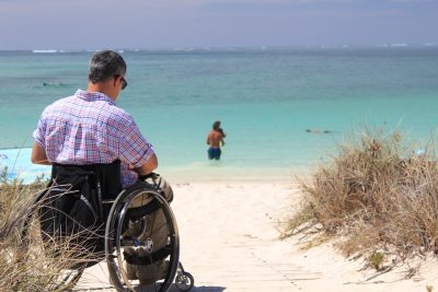 man in a wheelchair on the beach