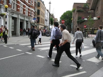 pedestrians crossing the road in a crosswalk