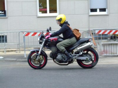 motorcyclist riding a motorcycle with a helmet