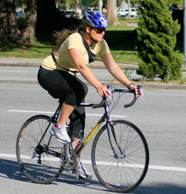 women at stop with her bike