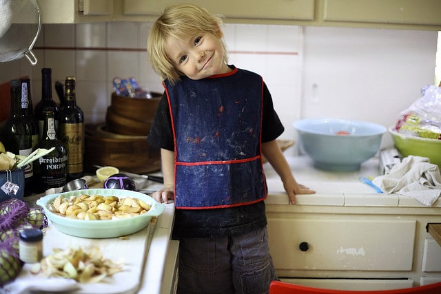 Boy smiles as he cooks