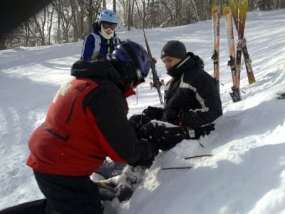 People helping an injured skier