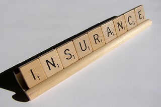 Insurance spelled out in scrabble tiles