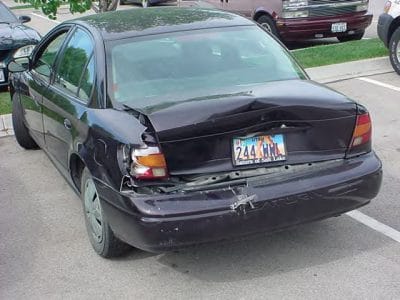 black sedan with rear damage from car accident