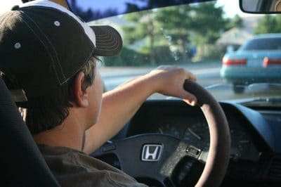 man driving behind the wheel