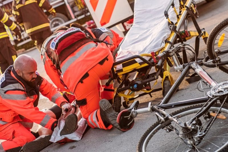 Paramedics helping injured cyclist