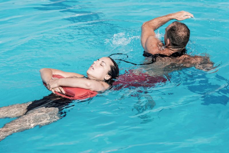 lifeguard saving kid from drowning in pool