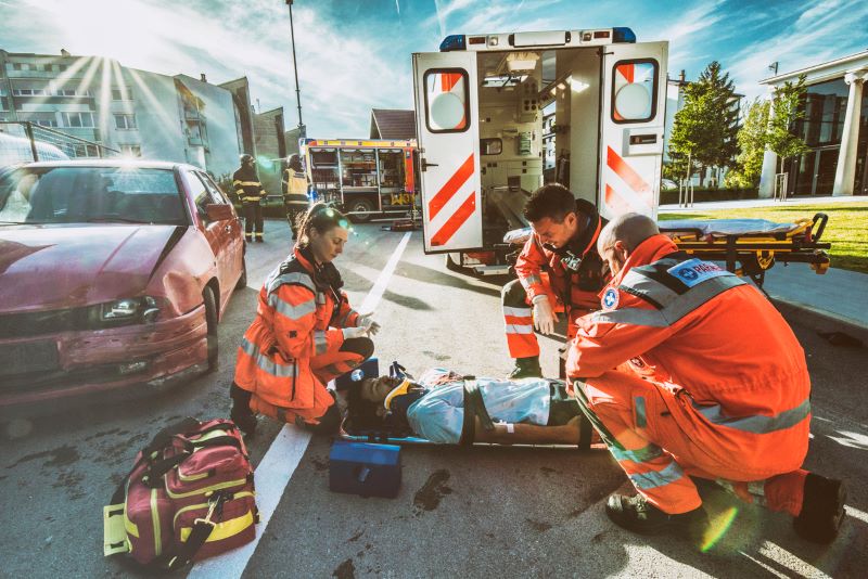 male on a stretcher with a neck brace after being in a car accident