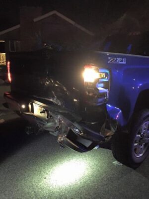 blue truck with rear end crushed after car accident